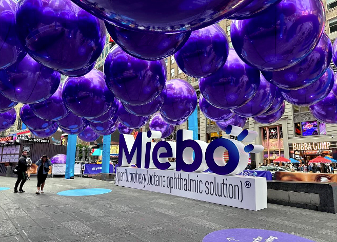 A large group of purple balloons hanging from the ceiling.